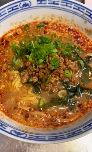 A bowl of TerraZen's red-broth ramen, scallions and minced filling